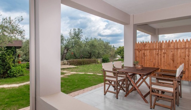 Nestled on the ground floor with direct garden access amidst olive trees in Psarou